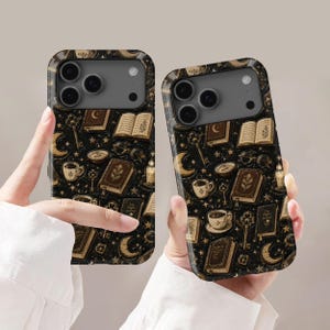May include: Two phone cases featuring a dark background with a repeating pattern of vintage books, crescent moons, keys, eyeglasses, candles, and cups of coffee. The design includes gold-toned illustrations of these items scattered across the surface.