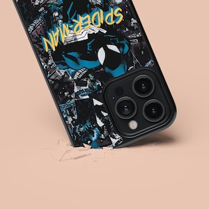 May include: A black phone case with a collage of comic book covers featuring Spider-Man. The case has a blue and black color scheme with the words "Spider-Man" in yellow lettering. The phone case has a camera lens with four lenses.