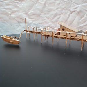 Pier with moored boat and house