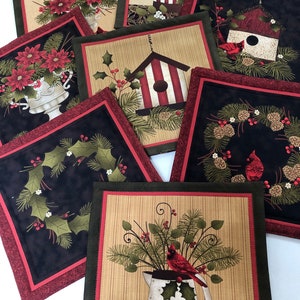 May include: Set of eight red and green Christmas-themed fabric coasters with various designs including a birdhouse, a wreath, a cardinal, and a pitcher of holly.