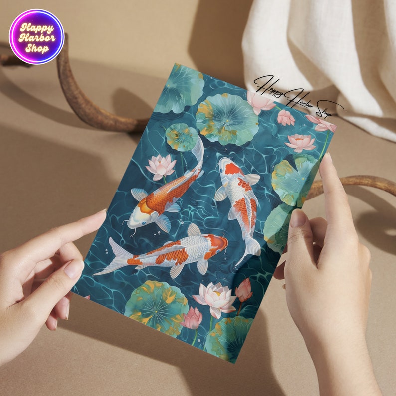 May include: Three orange and white koi fish swim in a blue pond with green lily pads and pink flowers. The water is rippling and the fish are swimming in different directions.
