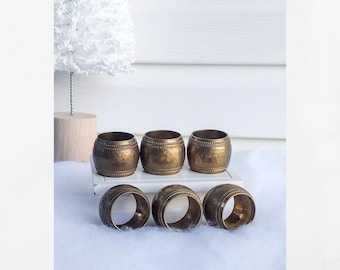 Vintage hammered brass napkin ring set.  6 pc.  Beaded edge.  1.5" tall. 1.5 " opening