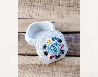 Vintage porcelain ceramic lidded trinket box.  Embossed trinket.  Blue rose trinket.