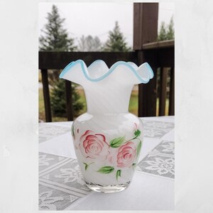 Vintage Fenton glass art vase. White opalescent glass. Optic swirl pattern. Aqua blue ruffled rim. Hand painted roses. 6&quot; tall.
