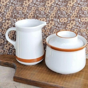 Vintage stoneware creamer and sugar bowl with lid.    hand painted.  cream color.  brown stripe.  made in Korea.  1970s