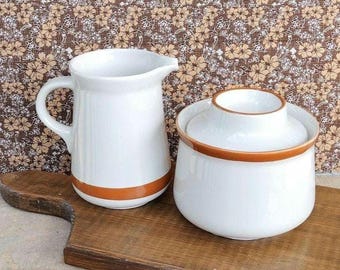 Vintage stoneware creamer and sugar bowl with lid.    hand painted.  cream color.  brown stripe.  made in Korea.  1970s