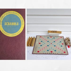 May include: Vintage Scrabble board game set. The game board is tan with red and blue squares. Includes wooden letter holders, a bag of wooden letter tiles, and a box with the Scrabble logo.