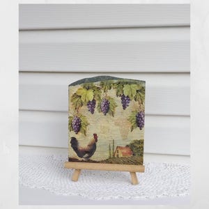 May include: A rustic wooden sign with the text "Welcome to our home" in white lettering. The sign features a distressed finish and a simple, inviting design, perfect for a front porch or entryway.