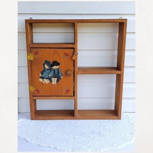 Vintage Hand crafted knick knack display shelf w/  door. Hand painted boy/girl.  5 compartment hanging Shelf. Curio shelf.   22.5 X 21 in.