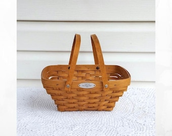 2006 Longaberger woven memories basket with poseable handles.  2 handle basket.  Natural woven basket.  Signed longaberger basket.
