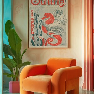 May include: An orange velvet armchair with rounded edges and a high back sits in a room with a teal and white tiled floor. A framed poster with the text "Outing for April" and a seahorse illustration hangs on the wall behind the chair.
