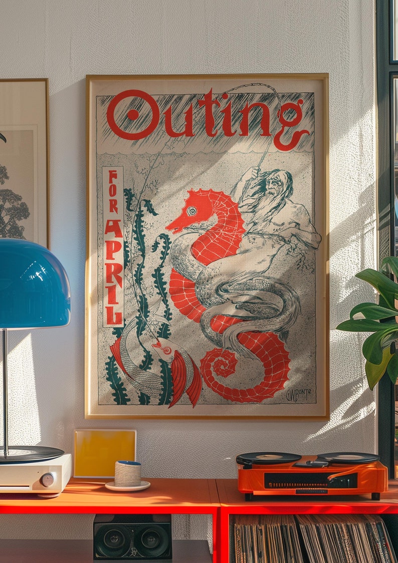 May include: A vintage poster for "Outing" magazine, featuring a red seahorse with a man riding it. The poster is framed in a light wood frame and has the text "For April" printed on the side.