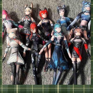 May include: A collection of nine anime-style dolls with various hair colors and outfits. The dolls have detailed facial features and are dressed in a mix of futuristic and fantasy-inspired clothing. The dolls are arranged closely together, with their arms outstretched.