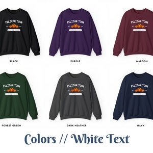 May include: Six different color sweatshirts with a white graphic design of a pumpkin patch with the text "PELICAN TOUN EST. STARBER VALLEY 2018" on the front. The colors are black, purple, maroon, forest green, dark heather, and navy.
