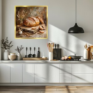 May include: A still life painting of a loaf of bread and slices of bread on a wooden table with wheat stalks and a garlic bulb. The painting is framed in gold.
