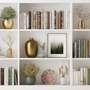 May include: A white bookshelf filled with books, decorative vases, and potted plants. The books are of various sizes and colors. Gold and green vases and pots add a touch of elegance. A framed forest landscape art piece is also present.