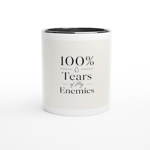 May include: A white ceramic mug with a black interior and rim. The front features black text that reads 100% Tears of My Enemies, with a small water drop icon centered between the percentage and the word Tears, printed in a clean serif font.