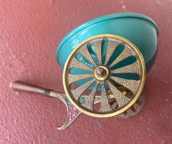 Vintage bowl on wheels designed in the shape of a wheelbarrow