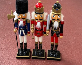 set of three vintage  " Holiday Nutcrackers " hand-painted wood