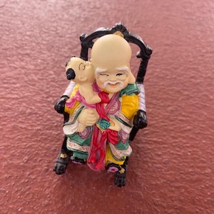 Vintage  Resin Chinese statue with a rocking chair hand painted.