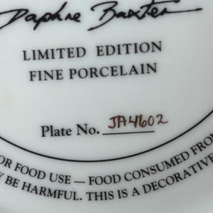 May include: White porcelain plate with black text that reads "LIMITED EDITION FINE PORCELAIN" and "Plate No. JA4602". The plate is signed "Daphne Baxter". The plate is for decorative use only.