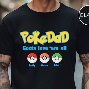 May include: Black t-shirt with the text "PokeDad Gotta love 'em all" and three Pokeball images with the names "Emily", "Adam", and "John" underneath.