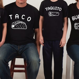 May include: A family of four wearing black t-shirts with white text and images of Mexican food. The shirts say "Taco", "Taquito", "Taquito", and "Burrito".