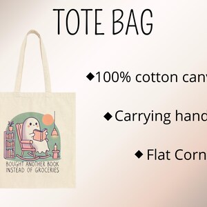 A natural-colored tote bag featuring a cute ghost reading a book with a humorous message about choosing books over groceries. The text says: Bought Another Book Instead Of Groceries. Main colors are blue, orange, white, pink and black.