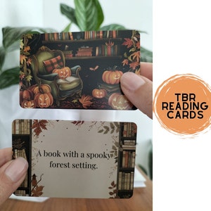 A set of small cards, each beautifully designed with Halloween-themed imagery, and titled: Halloween Whispers- A TBR and Activity Spellbook. In the colors orange, black and brown. The cards offer 27 reading prompts and 6 activities.