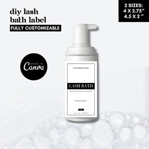 May include: White bottle with a black label that says "LASH BATH REVIVE REFRESH & RADIATE" and "YOUR BRAND NAME". The label also says "MADE IN Canva" and "2 SIZES: 4 X 2.75" 4.5 X 2"". The bottle is sitting on a white background with white bubbles.