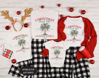 May include: White t-shirts and a onesie with a Christmas Beach Club design, featuring a palm tree and the text "CANCUN 2025 JACKSON FAMILY". The shirts are paired with black and white plaid pajama pants. Red accents include a cardigan, ornaments, and a headband.