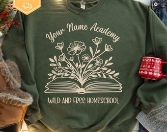 May include: Green sweatshirt with the text "Your Name Academy" and "Wild and Free Homeschool" with a book and flowers graphic.