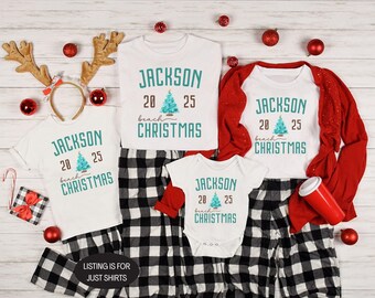 May include: White t-shirts and a onesie with the text "JACKSON 20 25 beach CHRISTMAS" in teal. The shirts are paired with black and white plaid pajama pants. Red accents include a cardigan, ornaments, and a reindeer antler headband.