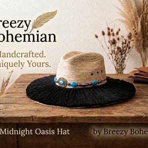 May include: A straw hat with a wide black fringed brim and a crown featuring a band of turquoise beads and a silver-toned metal accent. The text Breezy Bohemian, Handcrafted. Uniquely Yours. The Midnight Oasis Hat by Breezy Bohemian is visible.