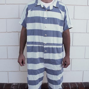 May include: A blue and white striped jumpsuit with a button-up front and a drawstring waist.