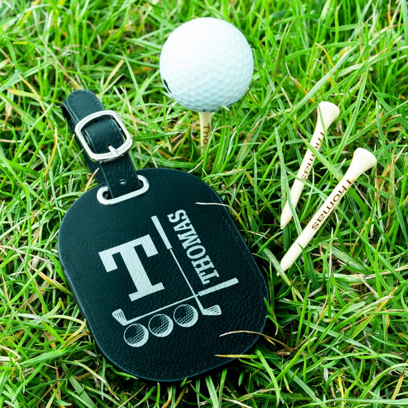 May include: Black leather luggage tag with a golf club and three golf balls, and the name "THOMAS" engraved on it.
