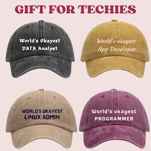 May include: Four baseball caps in different colours, each with the text "World's Okayest" and a different job title. The caps are black, brown, yellow and purple.