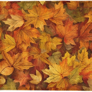 May include: A close-up of a collection of autumn leaves in shades of orange, yellow, and brown. The leaves are arranged in a random pattern, creating a natural and organic texture.