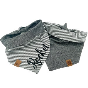 May include: Two gray dog bandanas. One is striped with the name "Rocket" in black script. The other is solid gray. Both have a brown tag with a logo. Pet accessories.