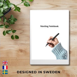 May include: White e-reader with a white frame and a black pen. The screen displays the text "Meeting Notebook".