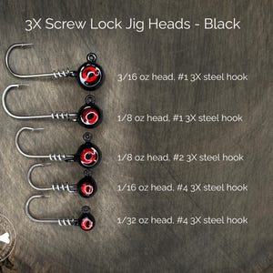 May include: Five black screw lock jig heads with red eyes. The jig heads are arranged vertically from largest to smallest. The jig heads are labeled with their weight and hook size. 3/16 oz head, #1 3X steel hook. 1/8 oz head, #1 3X steel hook. 1/8 oz head, #2 3X steel hook. 1/16 oz head, #4 3X steel hook. 1/32 oz head, #4 3X steel hook.