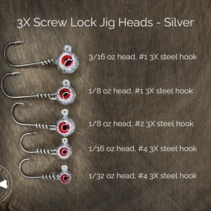 May include: Five silver screw lock jig heads with red eyes and different sized hooks. The jig heads are arranged vertically from largest to smallest. The jig heads are labeled with their weight and hook size. 3/16 oz head, #1 3X steel hook. 1/8 oz head, #1 3X steel hook. 1/8 oz head, #2 3X steel hook. 1/16 oz head, #4 3X steel hook. 1/32 oz head, #4 3X steel hook.