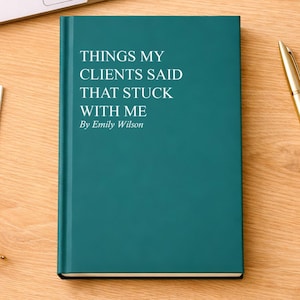 May include: A teal hardcover book titled "THINGS MY CLIENTS SAID THAT STUCK WITH ME By Emily Wilson" sits on a wooden desk. A laptop, pen, sticky notes, glasses, and a mouse are also on the desk.