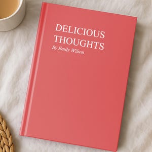 May include: A coral-colored book titled "DELICIOUS THOUGHTS" by Emily Wilson. A white mug filled with coffee sits to the left of the book. A woven placemat is below the mug.