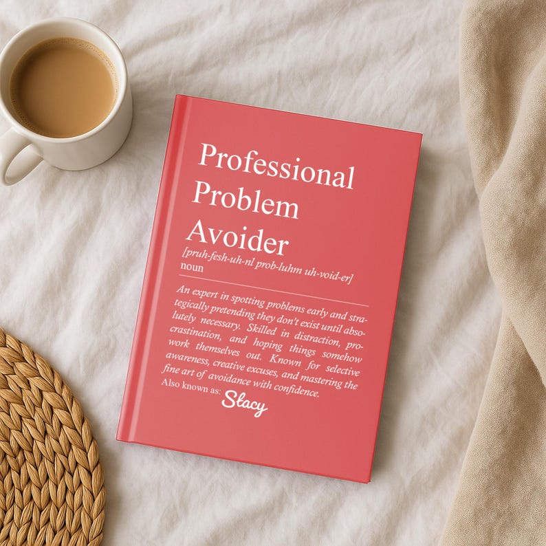 Personalized pink Professional Problem Avoider journal with a custom name placed on a cozy bed beside coffee, glasses, and a knitted blanket.