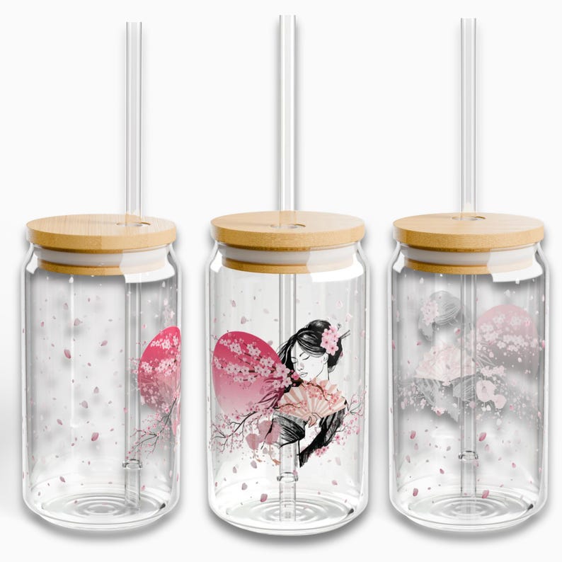 May include: Three glass tumblers with bamboo lids and clear drinking straws. Each tumbler features a different design with a Japanese woman, cherry blossoms, and a pink and white sunset.