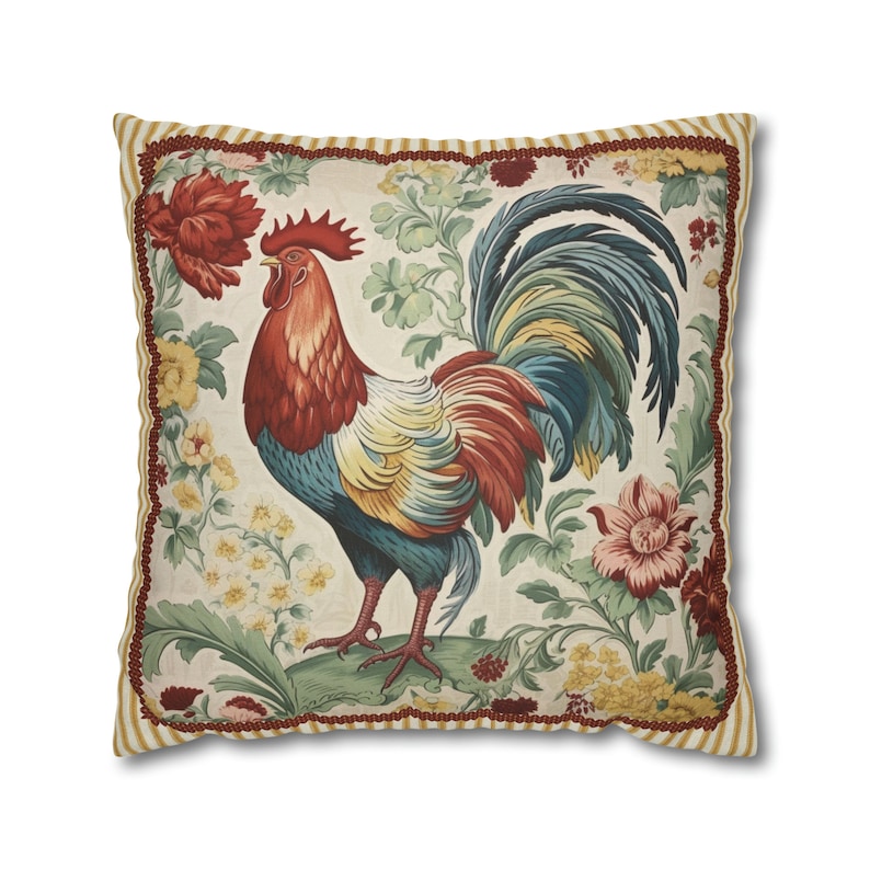 May include: A decorative throw pillow with a colorful rooster illustration surrounded by floral designs. The pillow has a cream background with a red, yellow, and brown border.