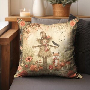 May include: A decorative throw pillow with a vintage autumn scene featuring a scarecrow, a fox, and a bird. The pillow has a cream background with brown, orange, and red accents.