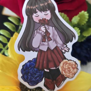 May include: A sticker featuring an anime-style illustration of a person holding a red flower. The person is wearing a white shirt, a red skirt, and black socks with red shoes. The sticker is surrounded by blue, yellow, and peach-colored flowers.