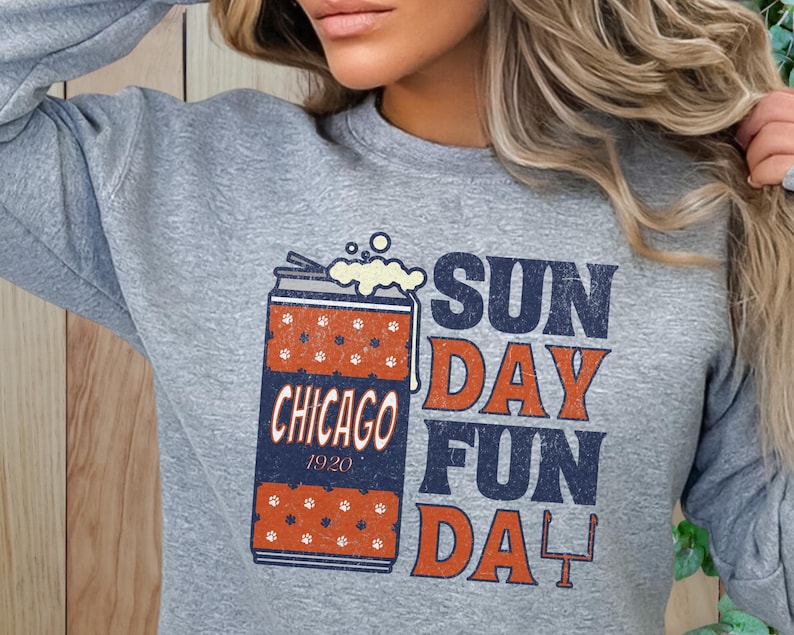 May include: Gray sweatshirt with a graphic of a beer can with the text "CHICAGO 1920" and the words "SUNDAY FUN DAY". The beer can has a red and white pattern.